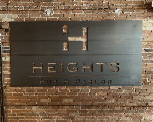 Heights_Logo_Metal Metal Sign with a large "H" logo and Heights Pub and Parlor